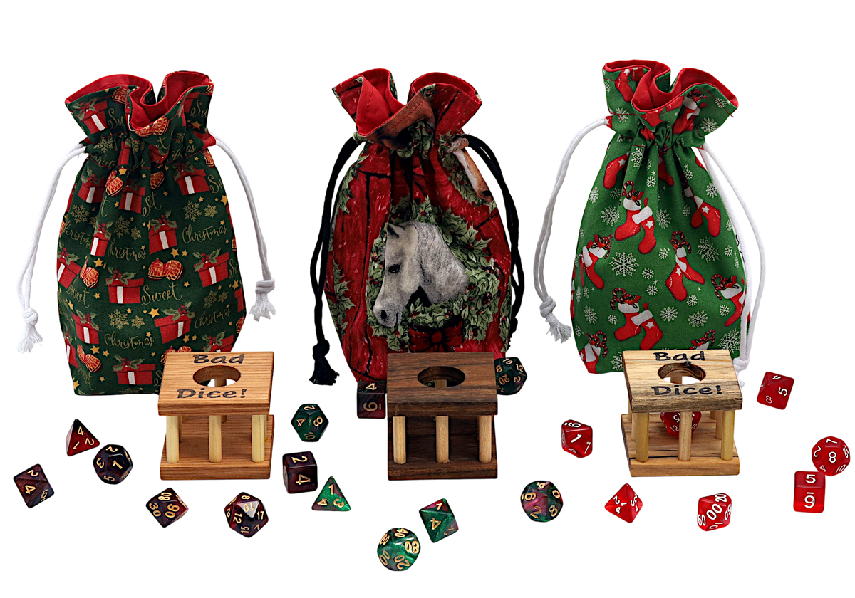 Three Christmas-themed drawstring dice bags with wooden dice jails and polyhedral dice displayed on a white background. The bags feature holiday patterns and a horse design, while the dice include red and green festive prints.