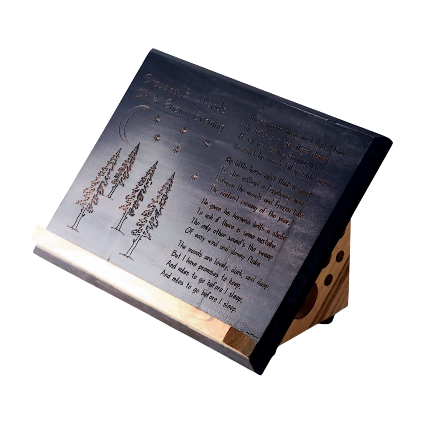Decorative wooden book stand with engraved text and tree illustrations on a white background
