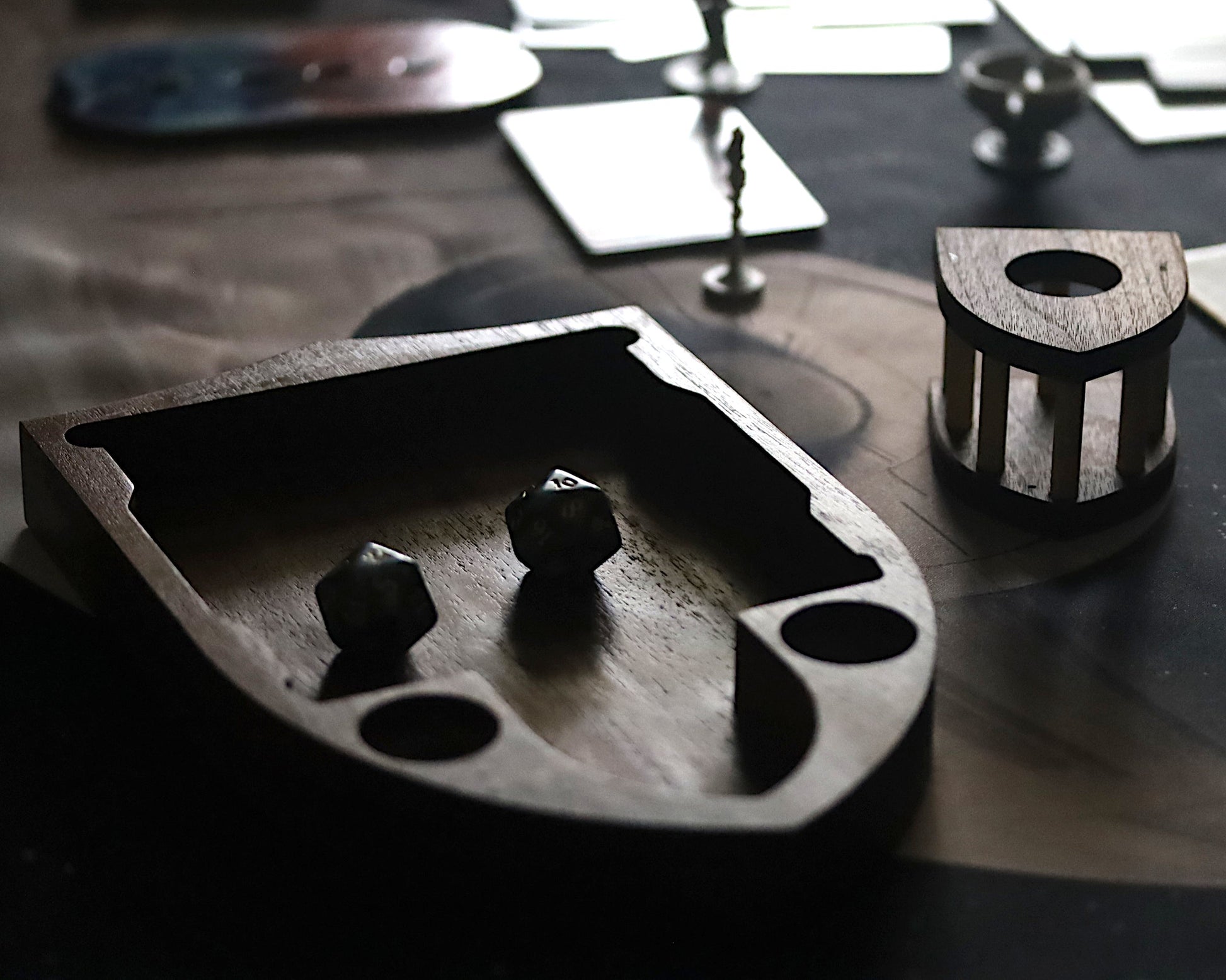 Wooden dice tray with dice on a dark surface